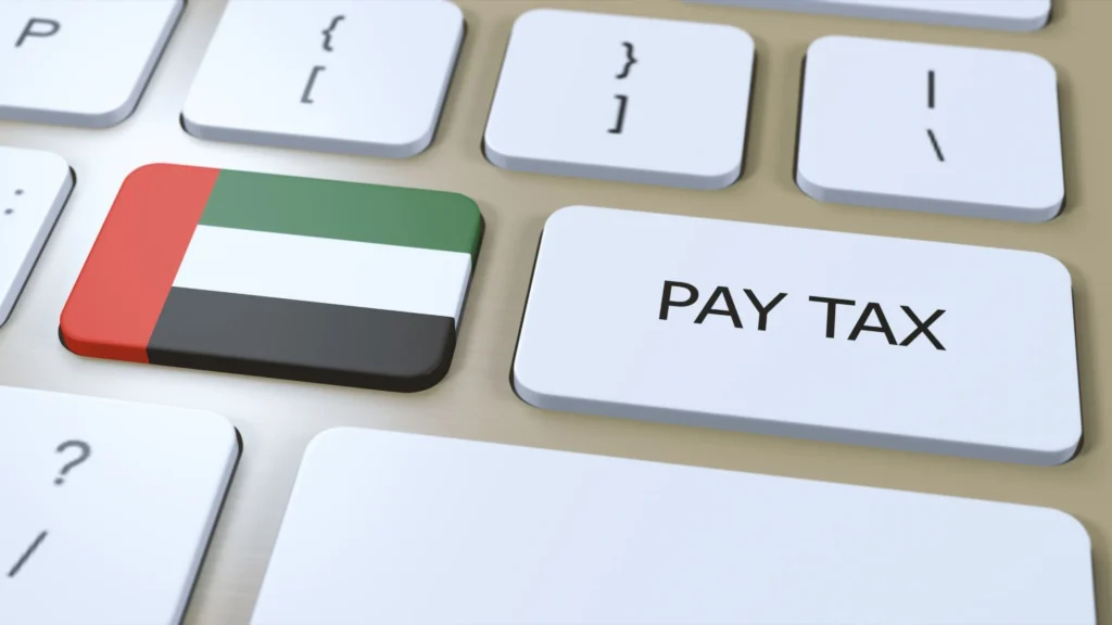 UAE VAT tax concept showing a keyboard with the UAE flag key and a Pay Tax button representing VAT registration and tax compliance in the UAE.
