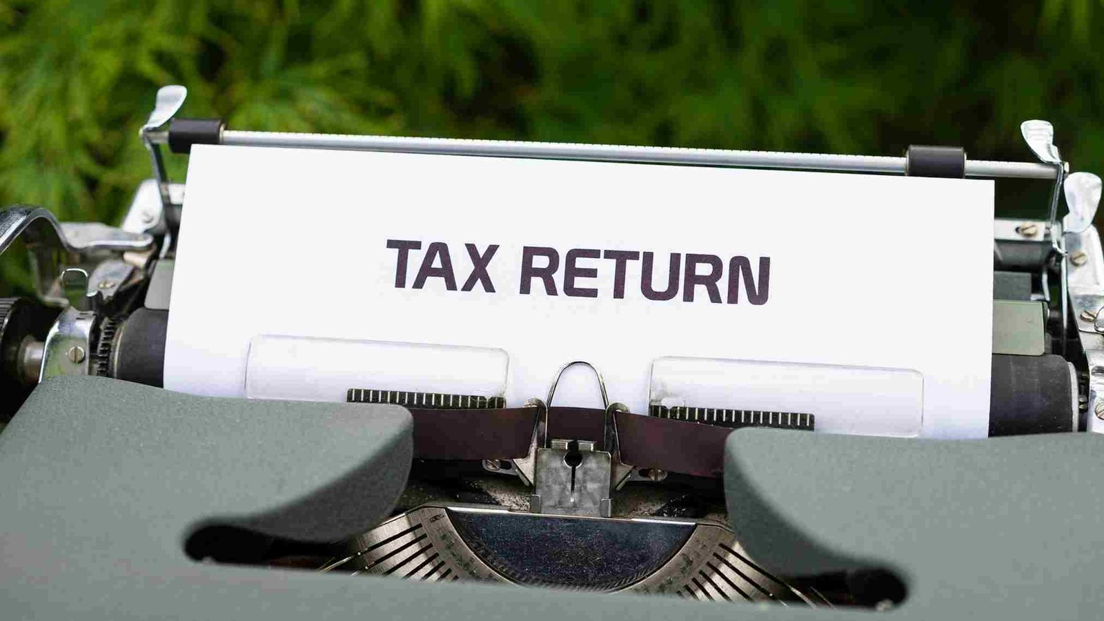 Tax return document displayed on a vintage typewriter